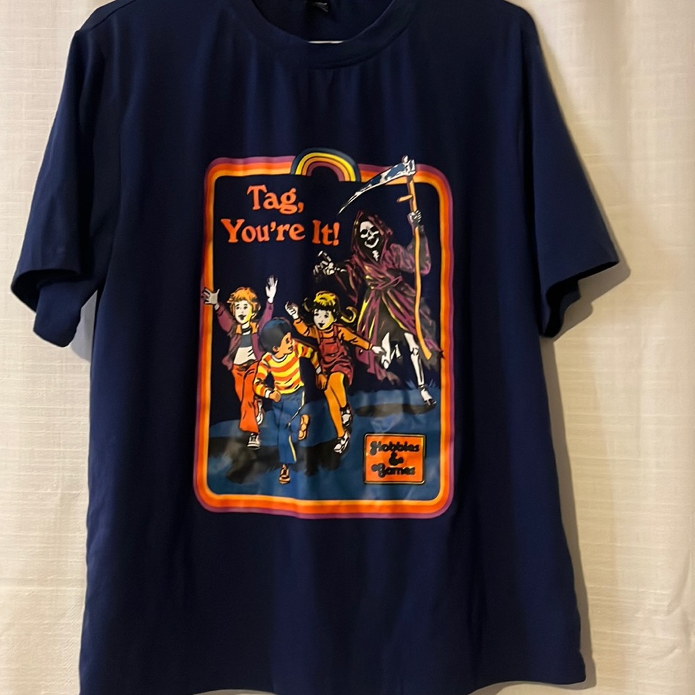 Navy blue “Tag You’re It” graphic T-shirt, with the Grim Reaper and children.